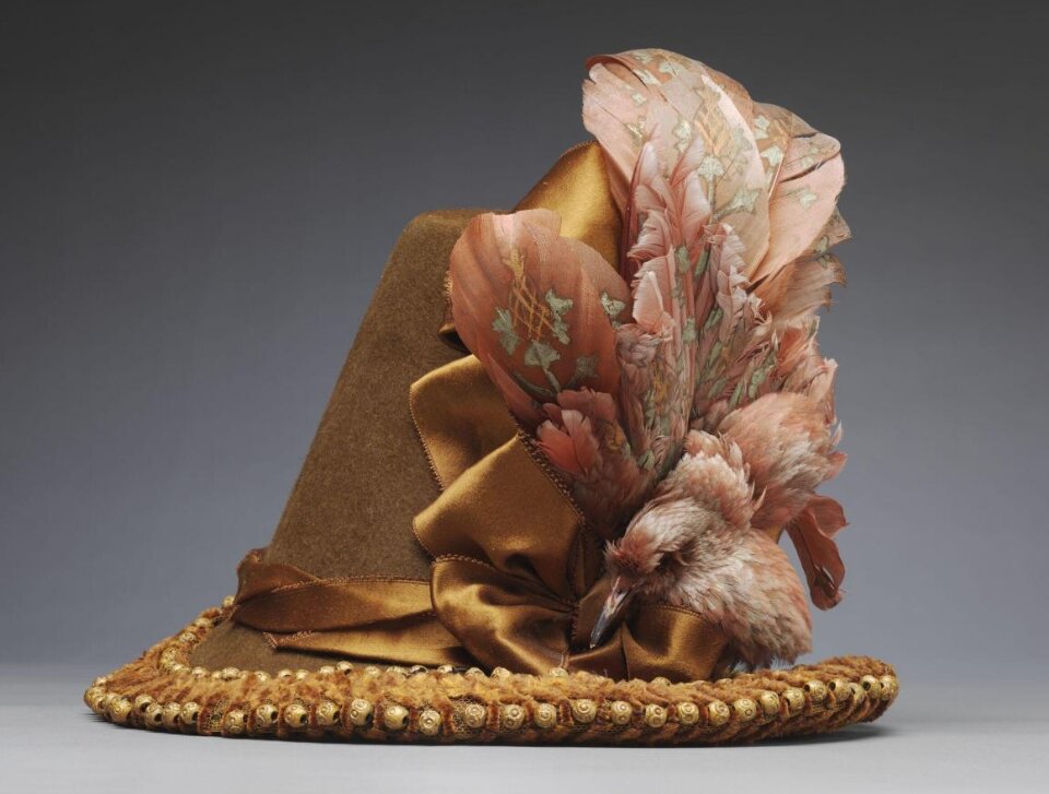 Hat, wool felt, trimmed with a starling (Sturnus vulgaris), goose or swan feathers, silk and sycamore beads, about 1885, Modes du Louvre Paris. Museum no. T.715:3-1997. © Victoria and Albert Museum, London