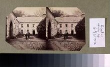 West Wing of Dundrum House with unidentified man with camera on tripod thumbnail 1