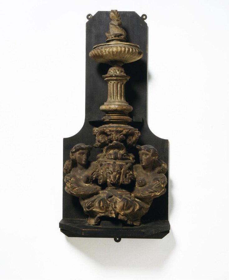 Finial of a fire-dog image