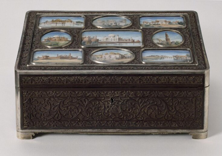 An oblong ebony box, carved with a floral pattern in relief, with an ivory miniature of the Qutb Minar, Delhi, on the lid. top image