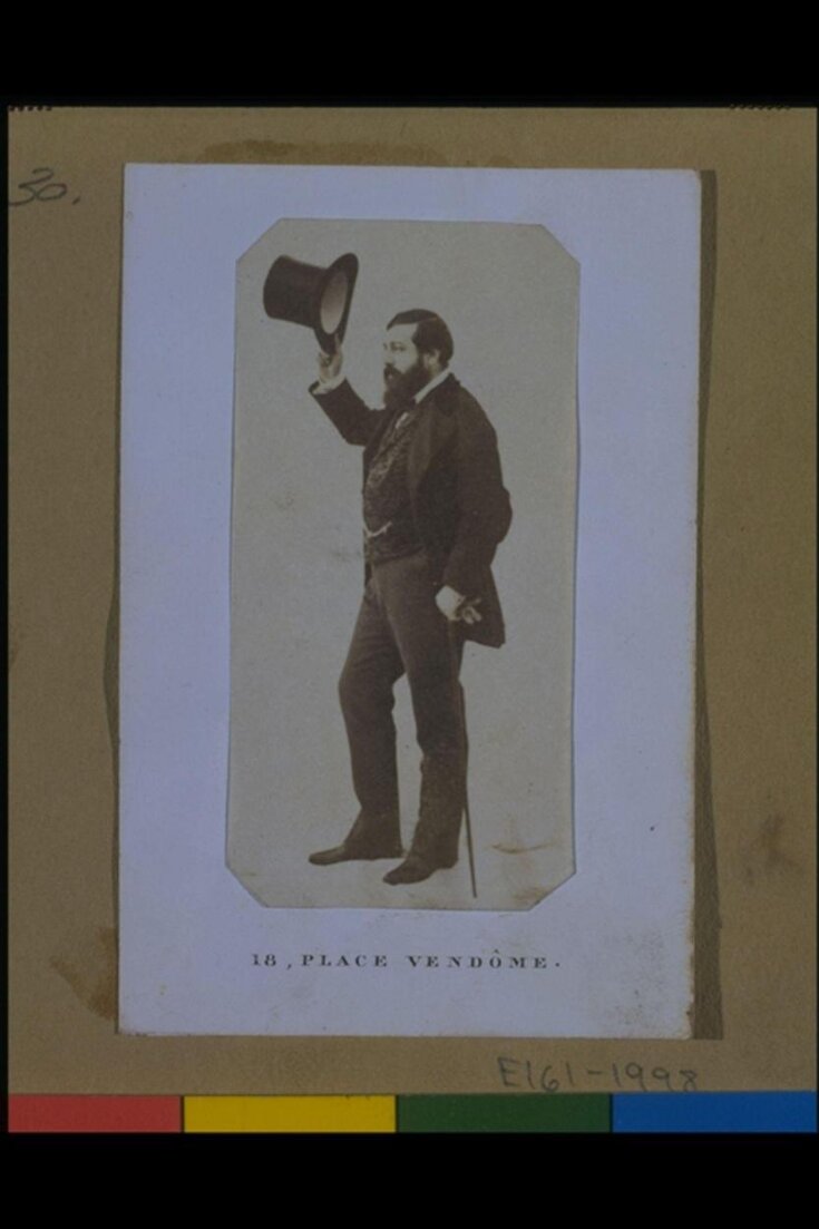 Photograph of man standing tipping his tophat top image
