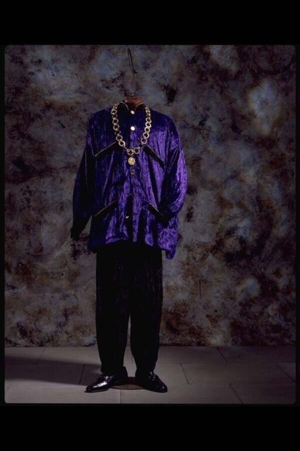 Oz of Against All Oz: purple crushed velvet jacket with black trim and gold buttons, worn with black crushed velvet trousers and a heavy gold chain