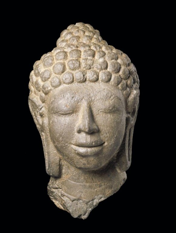 Head of the Buddha, sandstone, Thailand, 7th-8th century at the Victoria and Albert Museum