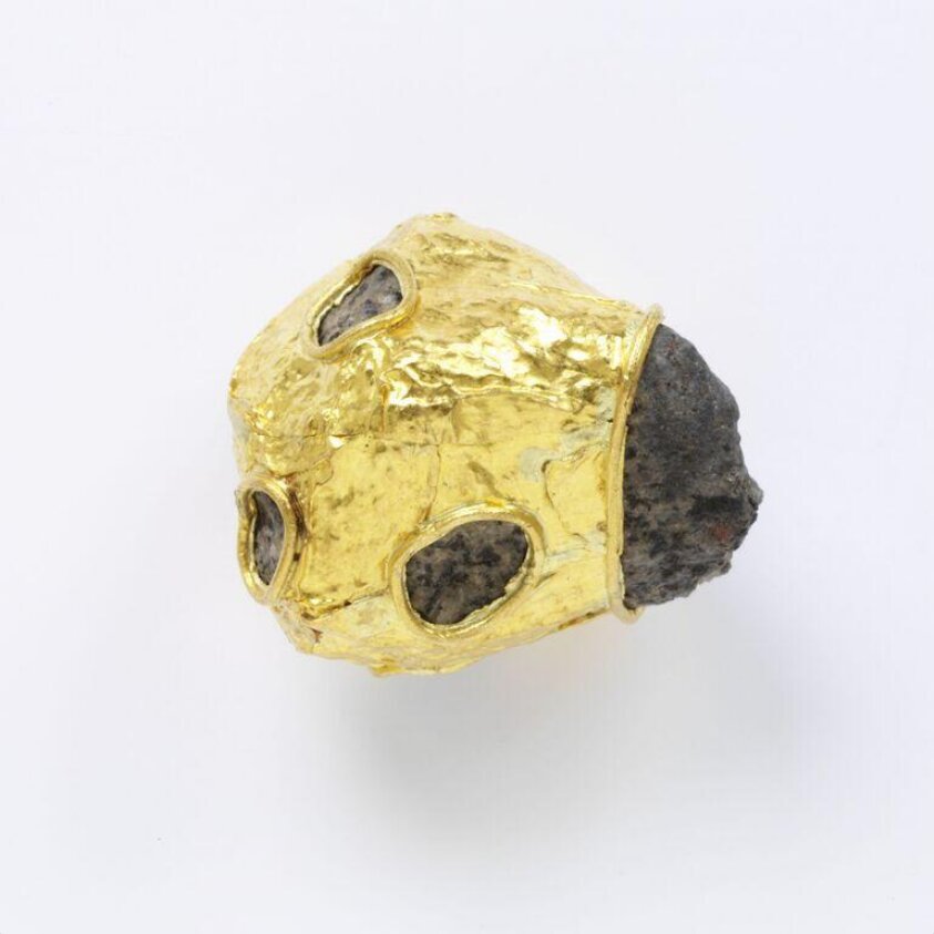 Natural rock wrapped in gold (1988) by Carl Krüger