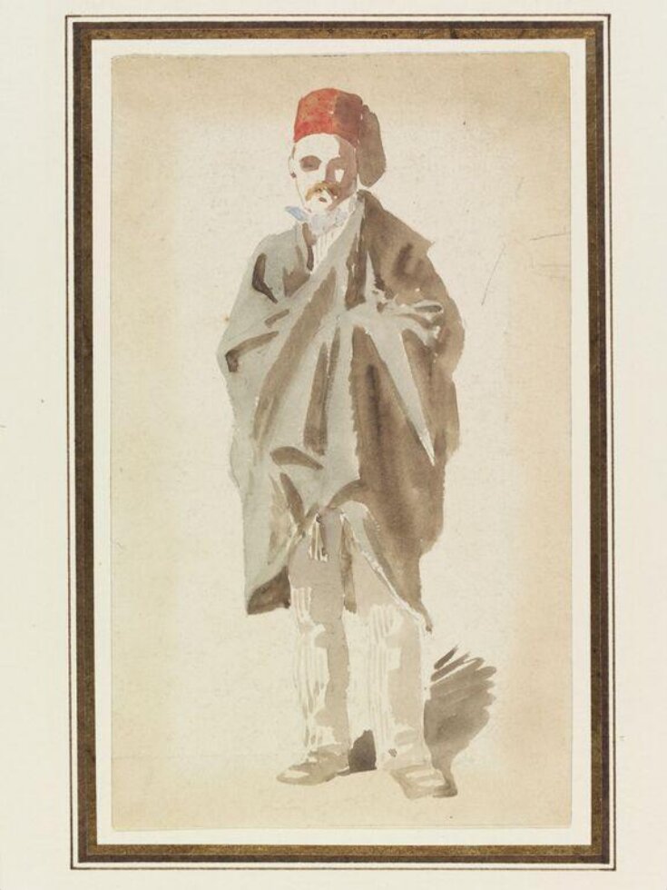 A man wearing a fez and wrapped in a long cloak top image