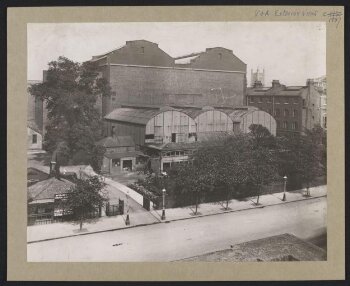 South Kensington Museum, remains of the 'Brompton Boilers', south of the Cast Courts, under demolition with Secretariat block on left, the Cast Courts in background and tower of Holy Trinity Church in distance