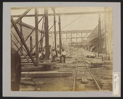 Construction of 1862 International Exhibition buildings, looking east, north court, with tower of Holy Trinity Brompton in background