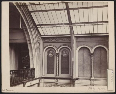 Interior view of the South Kensington Museum, north east corner of the South Court with partial view into Gallery 99, showing trial decoration with portraits of artists in roundels