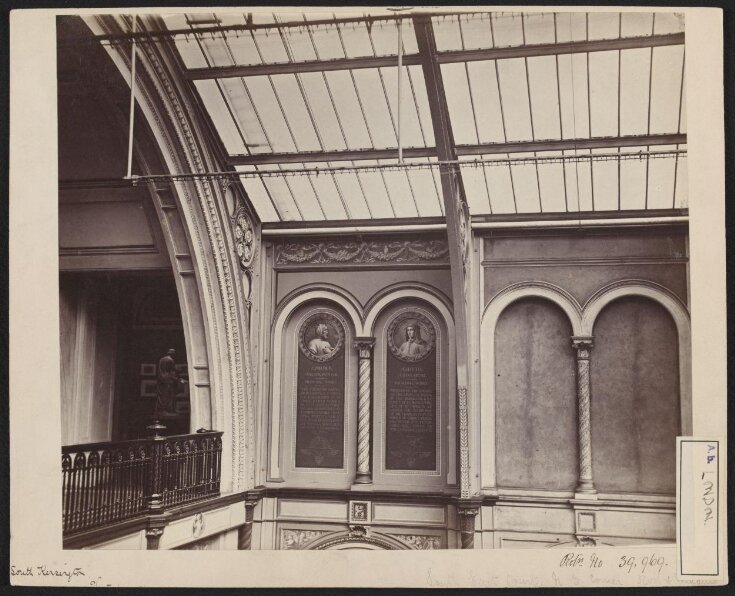 Interior view of the South Kensington Museum, north east corner of the South Court with partial view into Gallery 99, showing trial decoration with portraits of artists in roundels top image