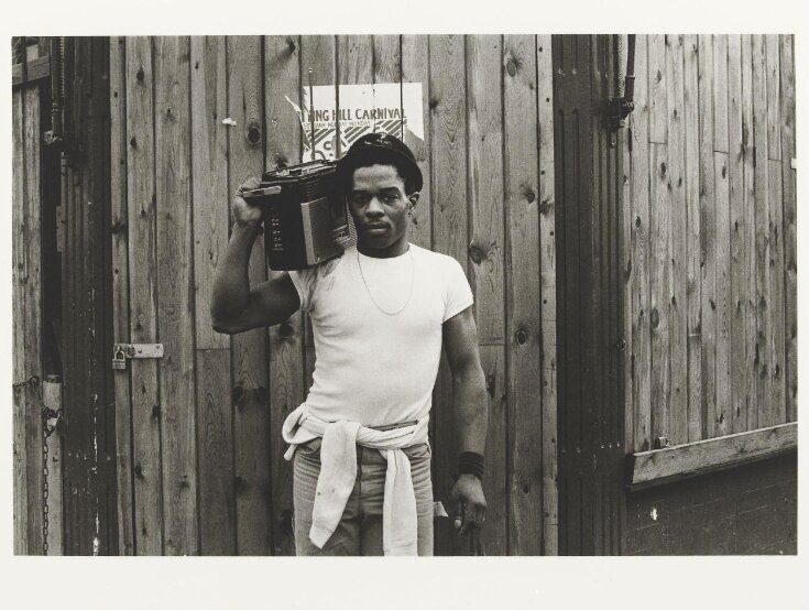 Untitled [Man with stereo on shoulder by Notting Hill Carnival poster] from the series On a Good Day top image