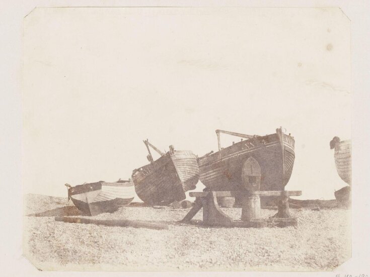 Boats and capstan on beach top image
