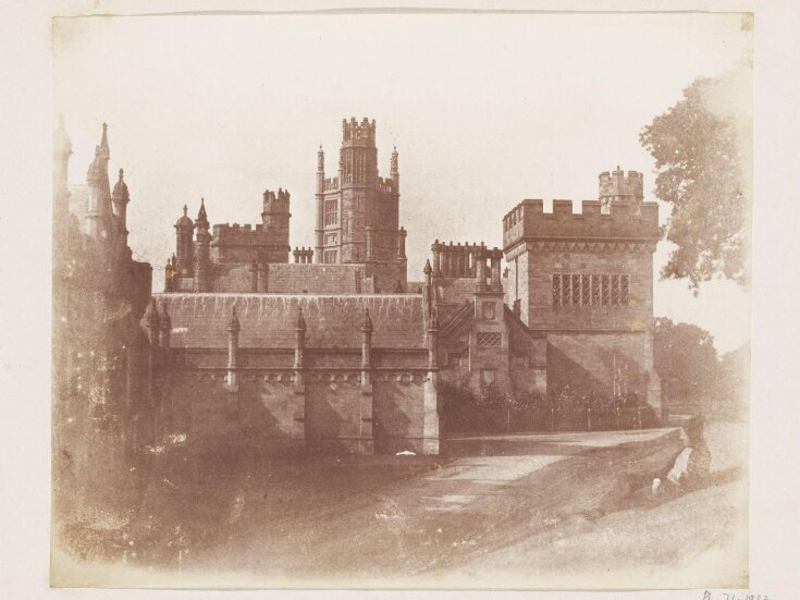 Margam Castle with a man recling on a grass bank top image