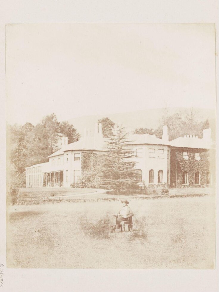 Man seated in the garden of Rheola House top image