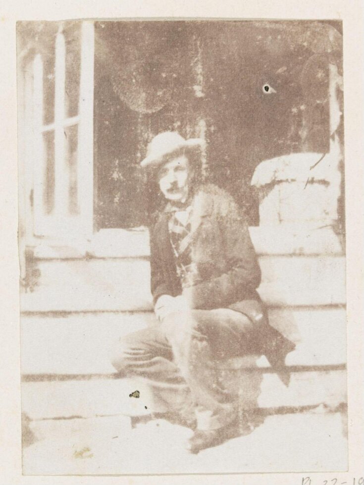 Man seated on steps top image