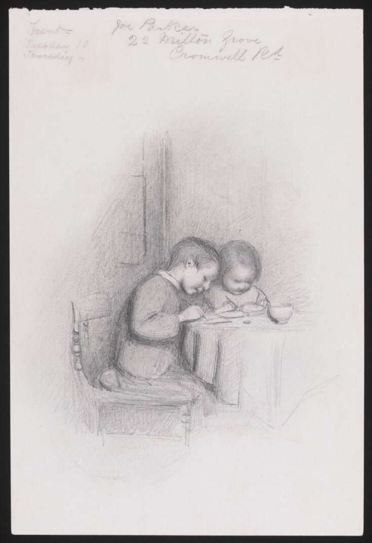 Two children seated at a table top image