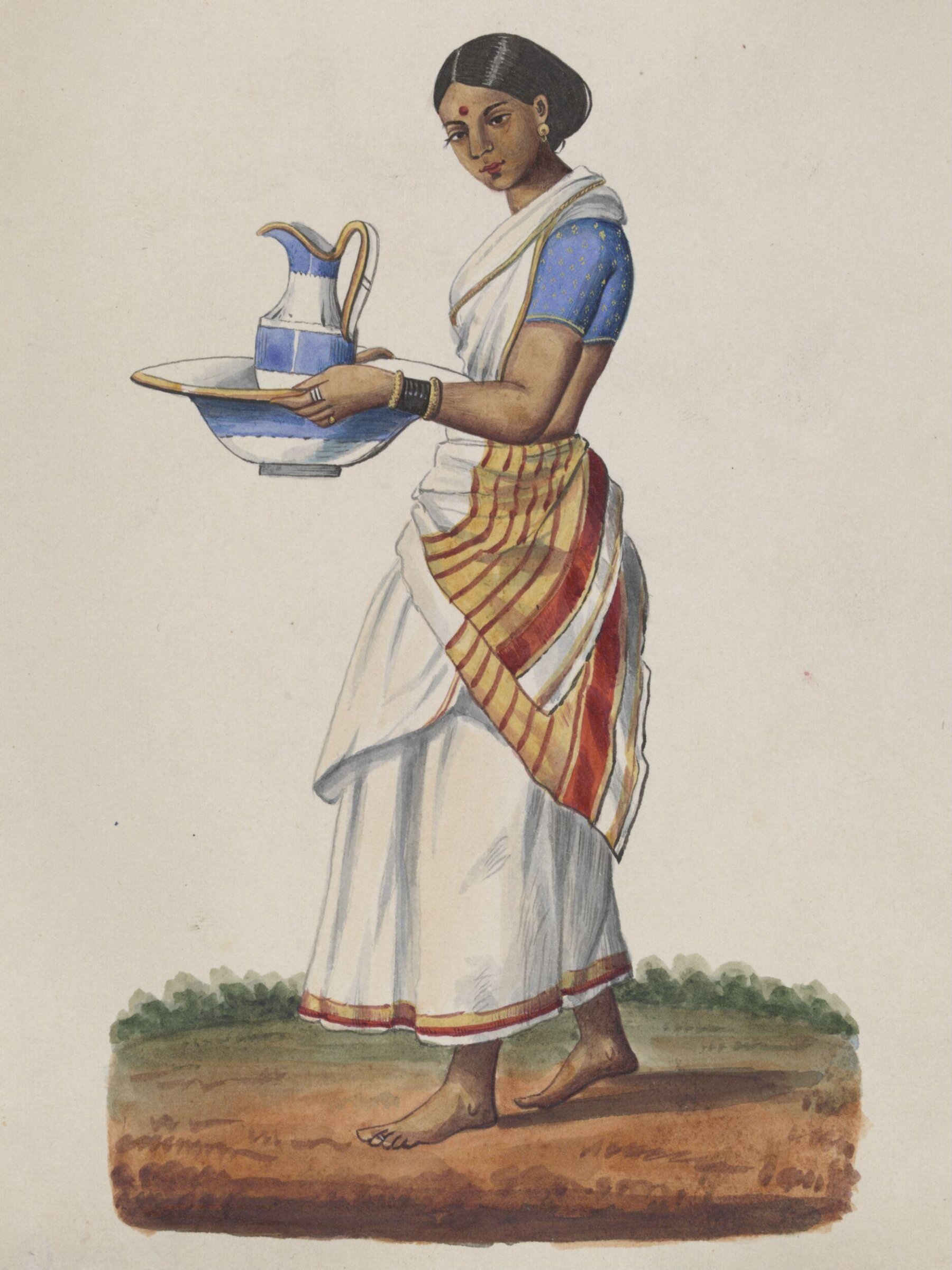 An ayah in a blue choli carrying a china ewer and basin, ca. 1860 - ca. 1870