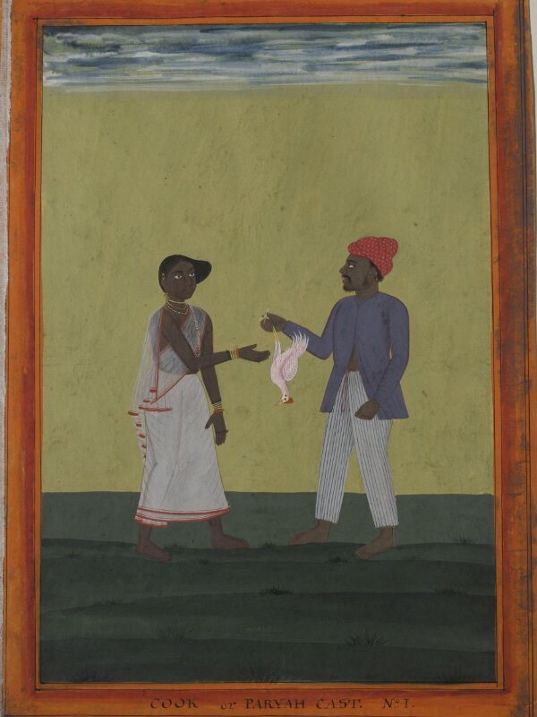 A cook holding a chicken