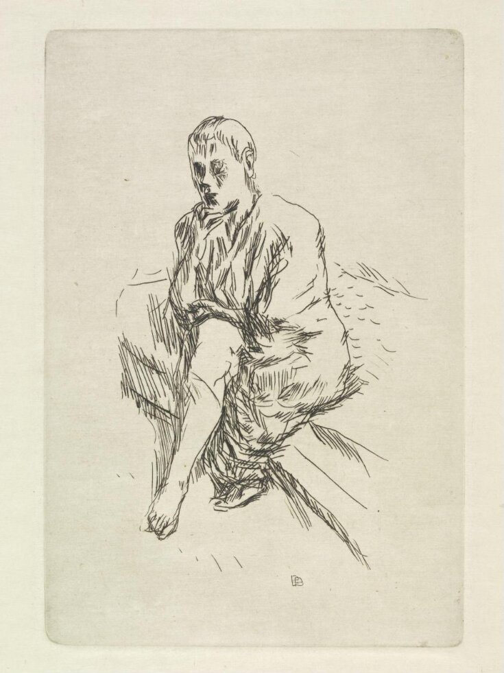 A young man seated on a bed top image