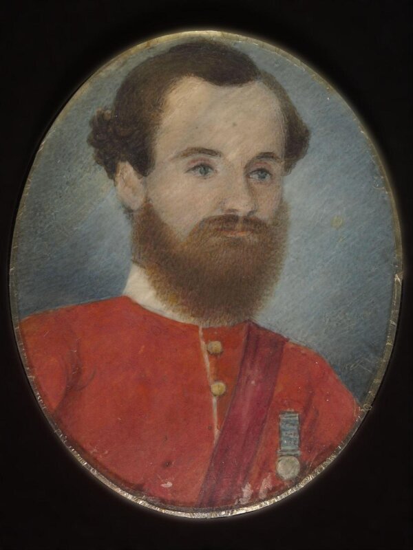 A European soldier in a red uniform wearing a medal.