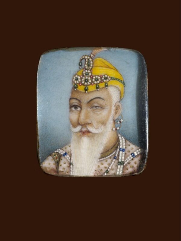 A wooden panel containing ten ivory miniatures, formerly mounted in two bracelets, depicting Indian rulers.