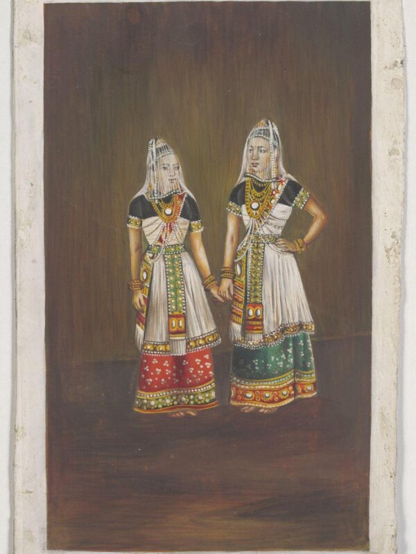 Two Manipuri dancing-girls standing together holding hands.
