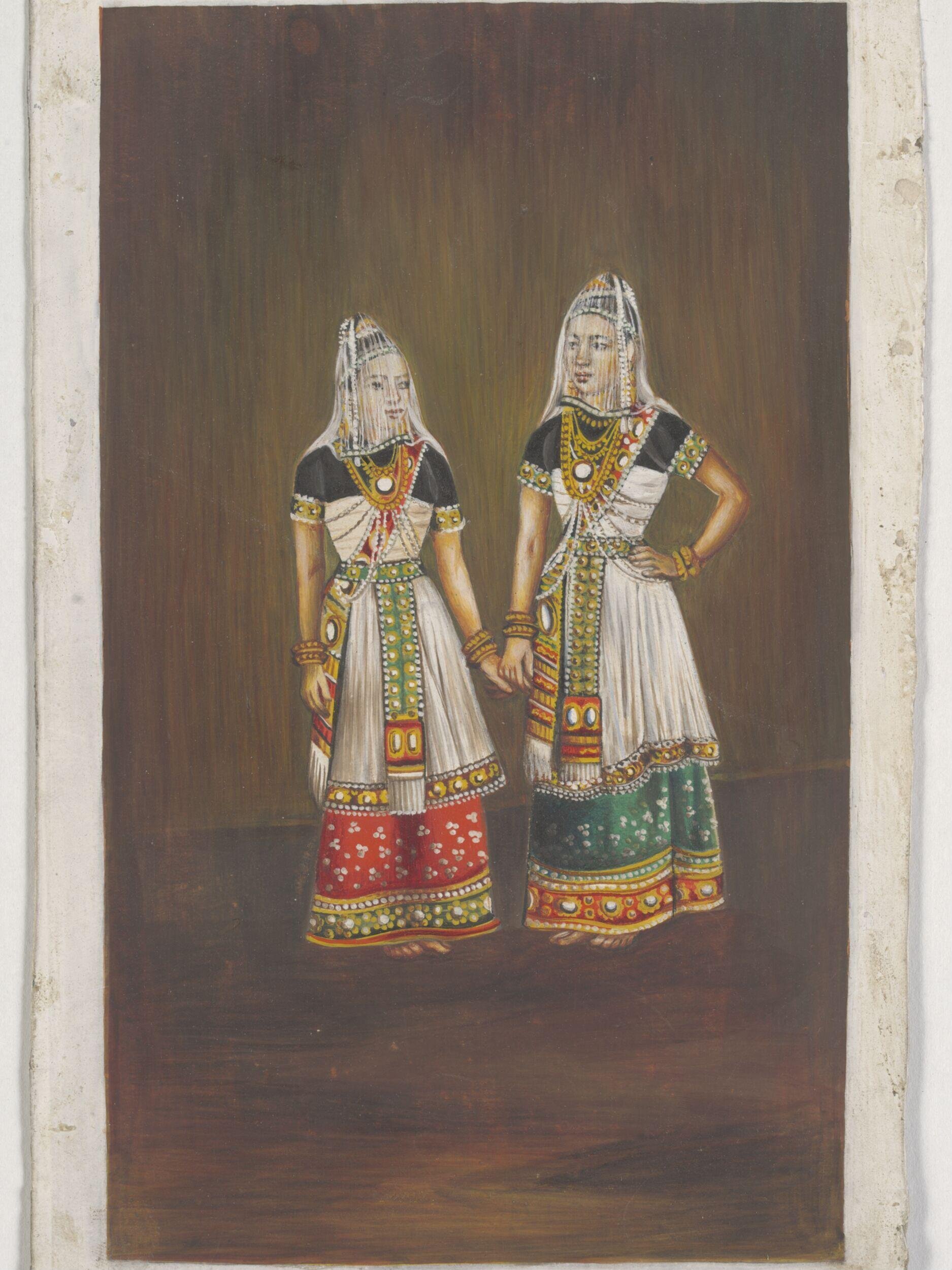 Two Manipuri dancing-girls standing together holding hands. by Unknown
