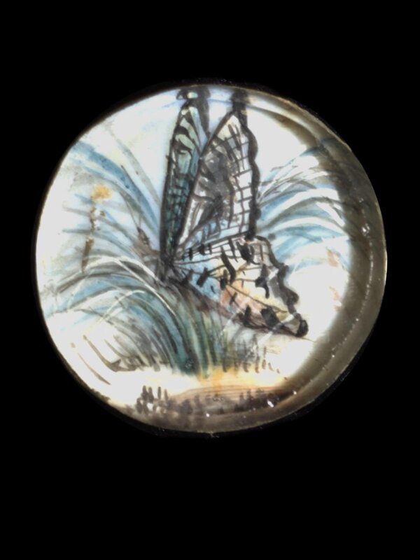 One of twenty-six ivory buttons painted with butterflies.