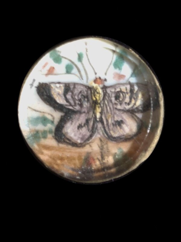 One of twenty-six ivory buttons painted with butterflies.