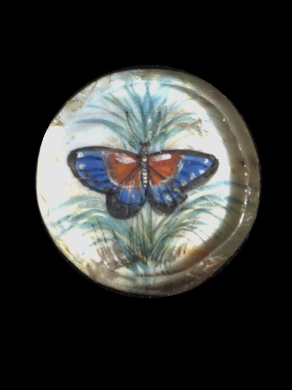 One of twenty-six ivory buttons painted with butterflies.