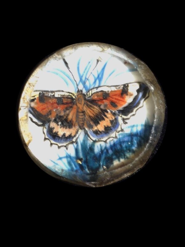 One of twenty-six ivory buttons painted with butterflies.