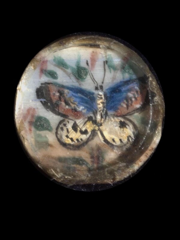 One of twenty-six ivory buttons painted with butterflies.