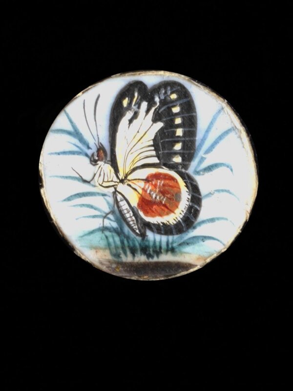 One of twenty-six ivory buttons painted with butterflies.