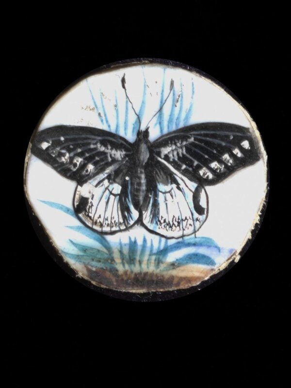 One of twenty-six ivory buttons painted with butterflies.