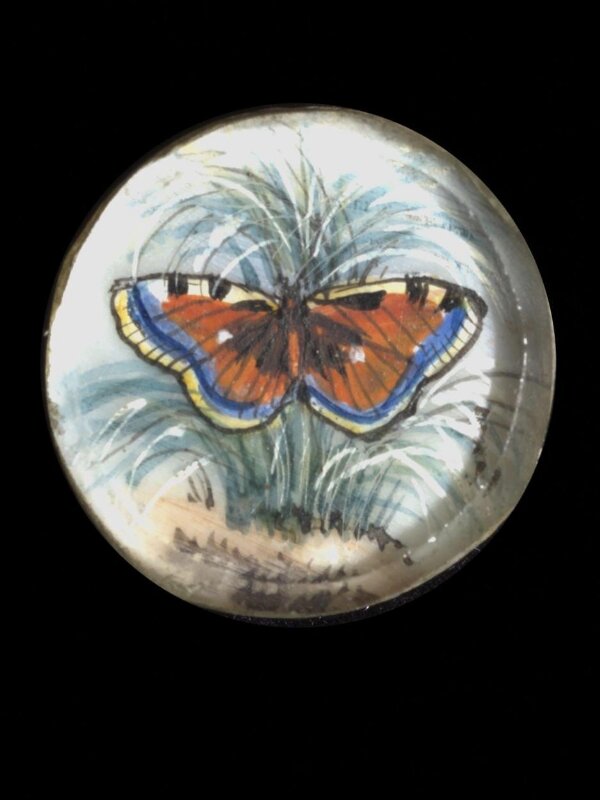 One of twenty-six ivory buttons painted with butterflies.