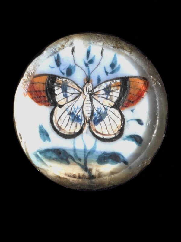 One of twenty-six ivory buttons painted with butterflies.