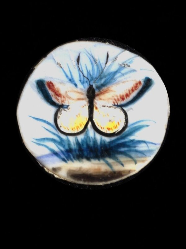 One of twenty-six ivory buttons painted with butterflies.