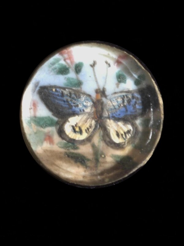 One of twenty-six ivory buttons painted with butterflies.