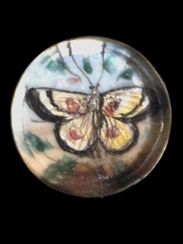 One of twenty-six ivory buttons painted with butterflies.