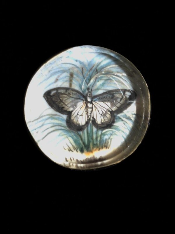 One of twenty-six ivory buttons painted with butterflies.