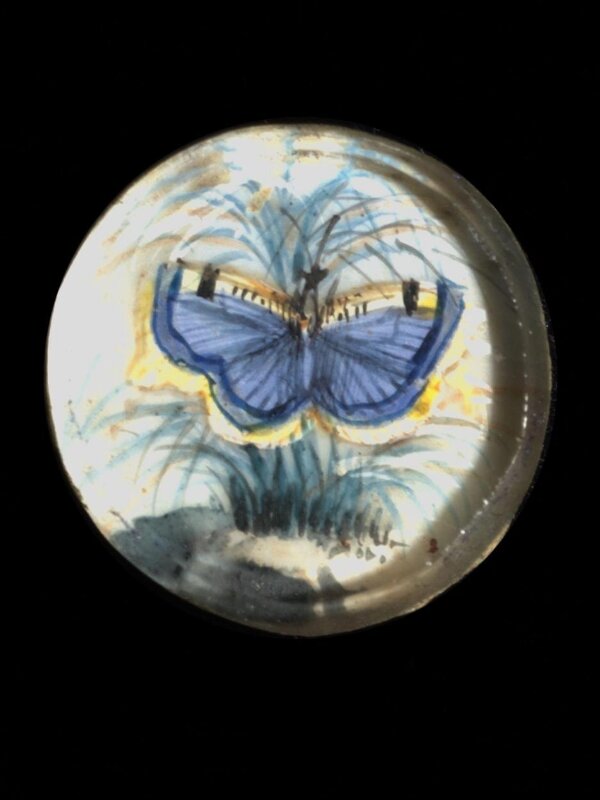 One of twenty-six ivory buttons painted with butterflies.