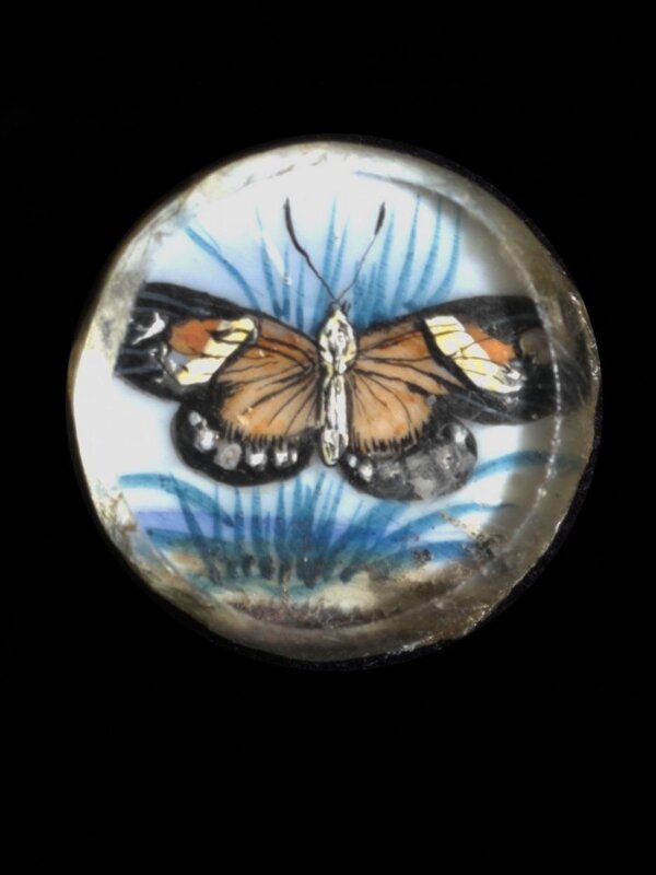 One of twenty-six ivory buttons painted with butterflies.