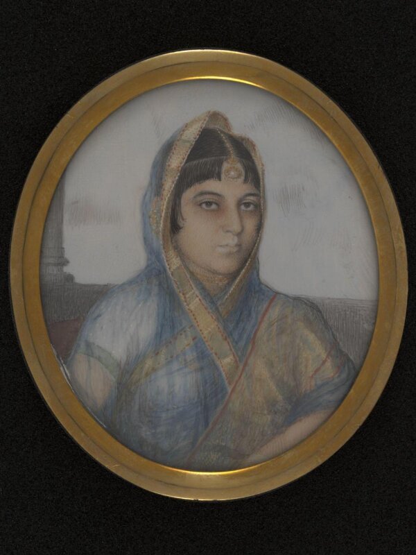 A lady in a blue, gold-edged sari.