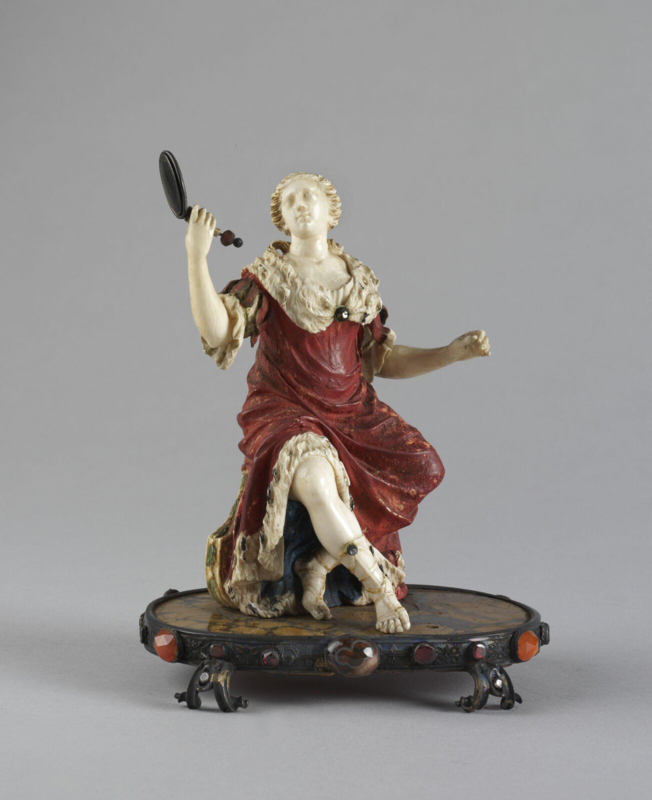 A lady seated holding a mirror, ca. 1750