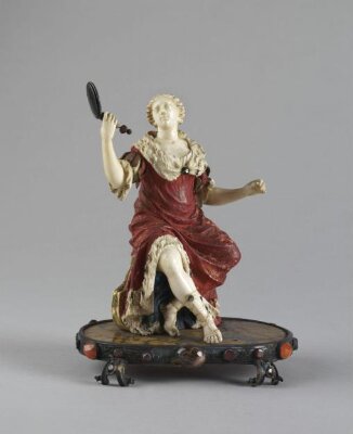 A lady seated holding a mirror, ca. 1750