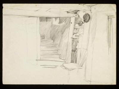 Bottom of a staircase with a hat and chair