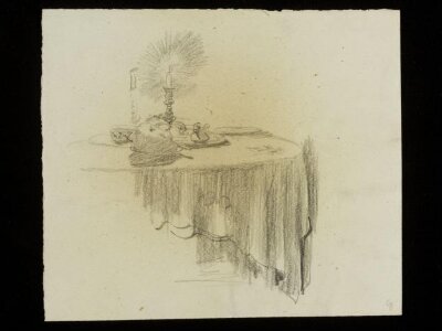 Table with a burning candle on top