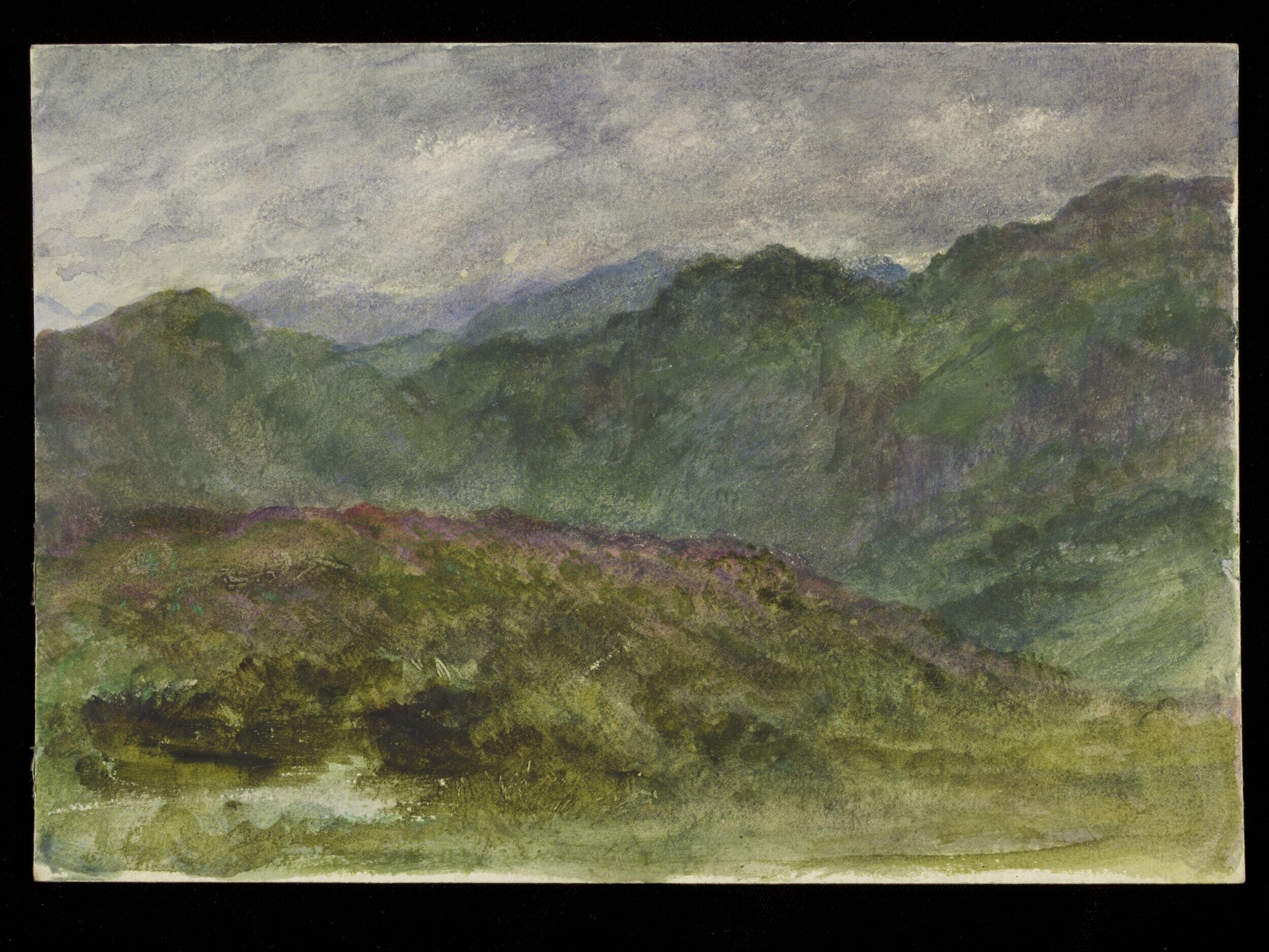 A Mountainous range under a heavy sky