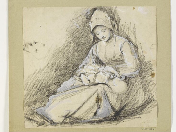 Seated woman nursing a baby top image