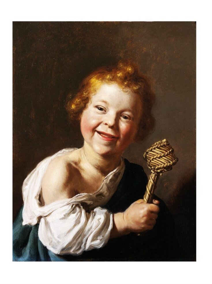 A laughing child holding a wicker rattle top image