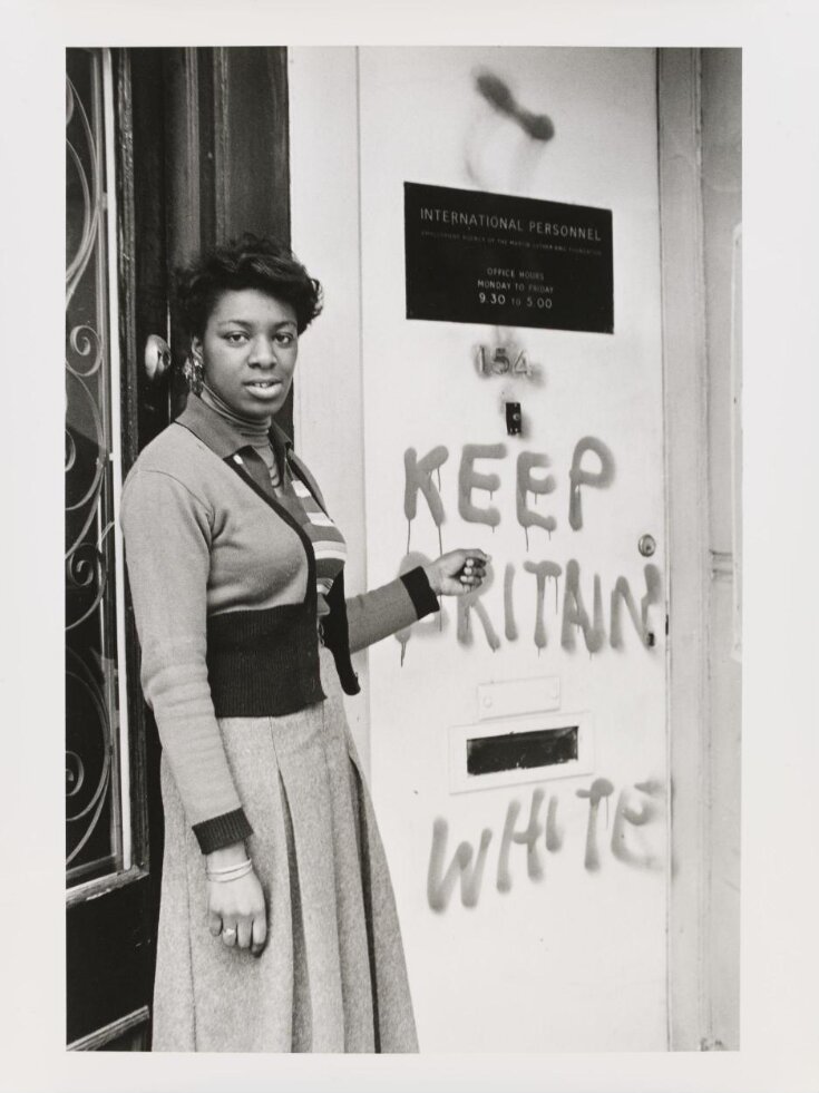 Untitled [Young lady points to 'Keep Britain White' graffiti at the International Personnel training centre in Balham] top image